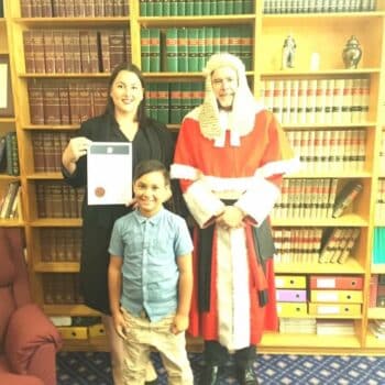 Photograph of Stephanie when she was admitted as a solicitor. She's with a Justice and her son.