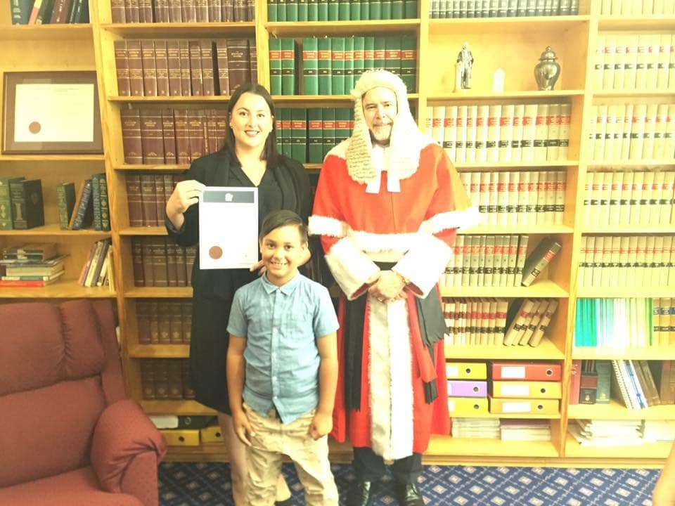 Photograph of Stephanie when she was admitted as a solicitor. She's with a Justice and her son.